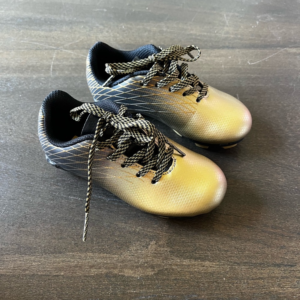 Toddler size 9 gold and black soccer cleats